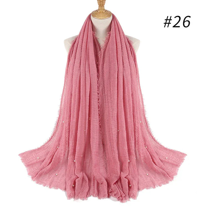 Soft pink textured scarf with small pearl embellishments displayed on mannequin, style #26