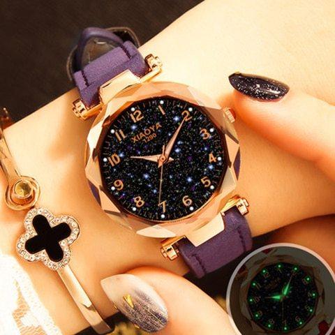 Fashion women's wristwatch with sparkling starry black dial, purple strap, and gold-tone case on wrist