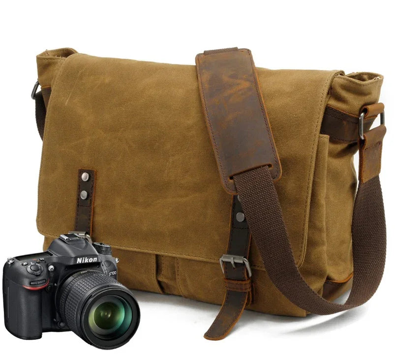 Brown canvas and leather camera messenger bag with Nikon DSLR camera on white background