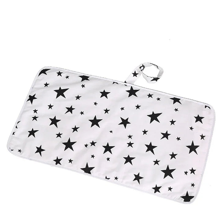 White rectangular fabric mat with black star pattern and a loop handle for hanging