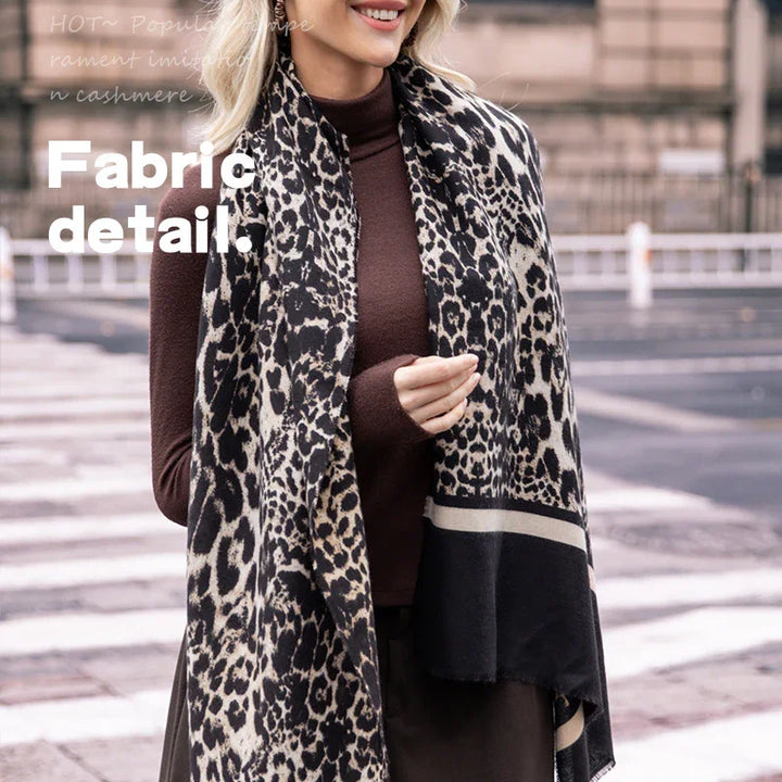 Woman wearing leopard print scarf and brown long-sleeve top outdoors fabric detail