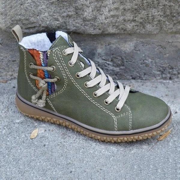 Olive green high-top sneaker with beige laces and colorful knit detail on cement surface