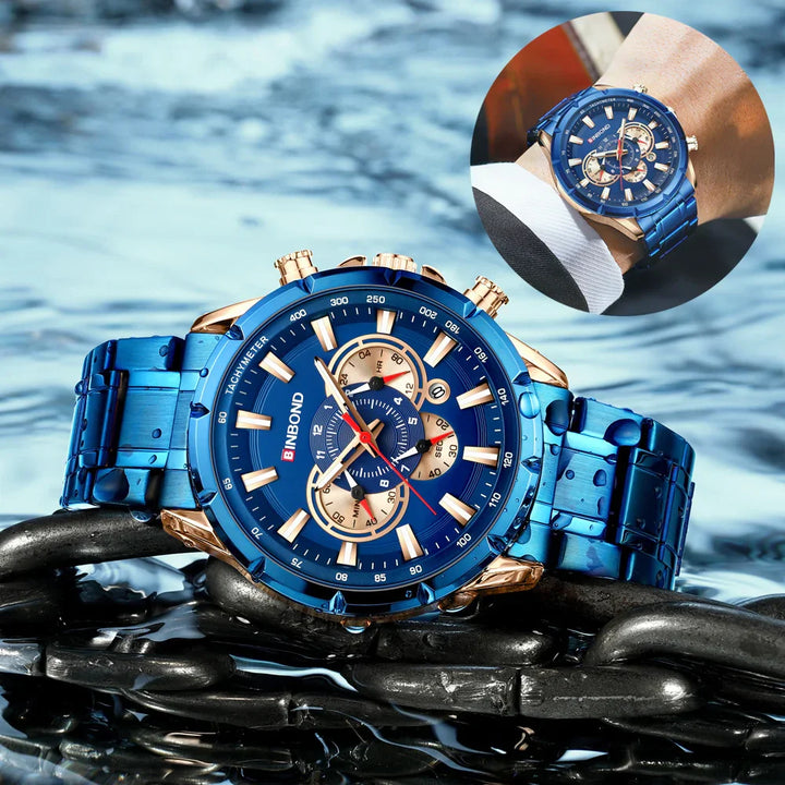Blue BINBOND men's chronograph watch with gold accents, tachymeter bezel, water droplets, and metal chain background