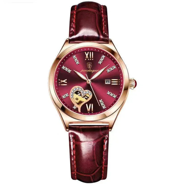 Elegant burgundy wristwatch with gold case, diamond hour markers, heart-shaped open balance, and leather strap