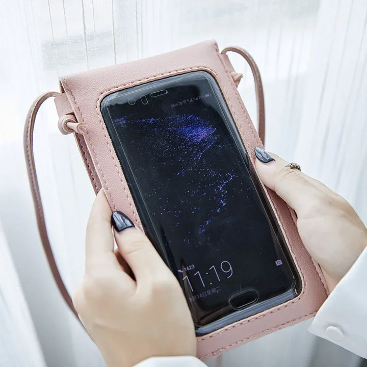 Pink leather phone pouch with clear screen window held by hands with black nail polish