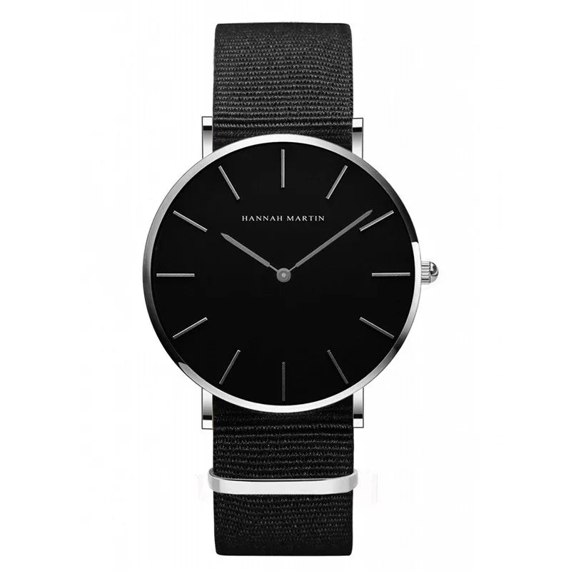 Minimalist black wristwatch with silver markers and black fabric strap by Hannah Martin