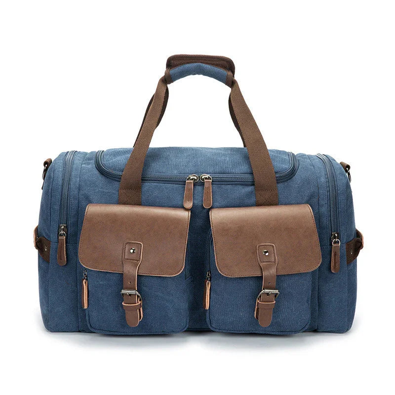 blue canvas duffle bag with brown leather pockets and straps, multiple zip compartments