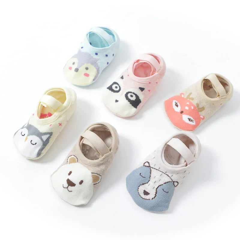 Set of six colorful baby socks featuring cute animal faces including owl, penguin, deer, bear, and raccoon designs
