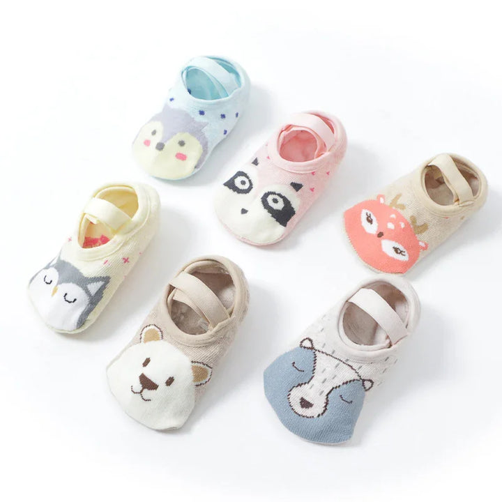 Set of six colorful baby socks featuring cute animal faces including owl, penguin, deer, bear, and raccoon designs