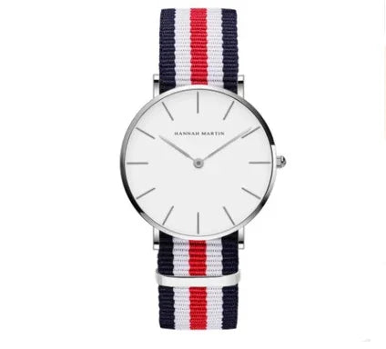 Minimalist Hannah Martin wristwatch with silver case and red, white, blue striped nylon strap
