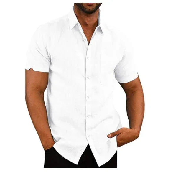 Man wearing a fitted white short-sleeve button-up shirt with collar, posing with hands in pockets