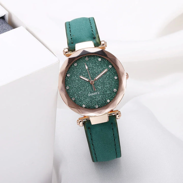 Elegant green quartz wristwatch with glitter dial and gold-tone round case on white background