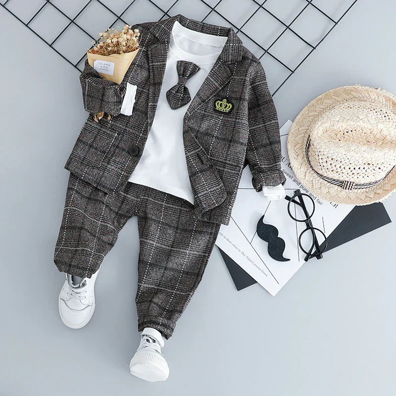 toddler plaid suit with matching pants and jacket, white shirt, bow tie, white sneakers, straw hat, and accessories