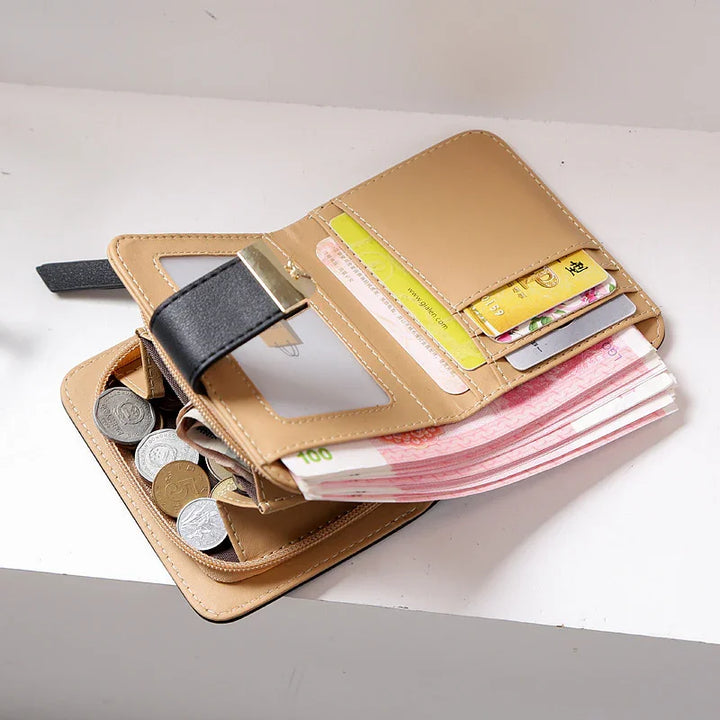 tan leather wallet open with multiple card slots, transparent ID window, paper currency, and coins compartment