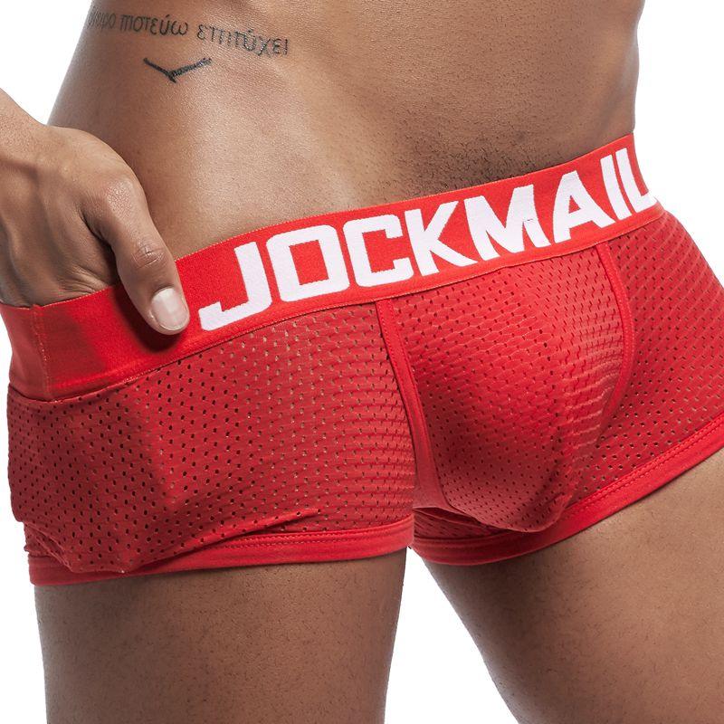 Close-up of man wearing red JOCKMAIL breathable mesh boxer briefs with thick white waistband