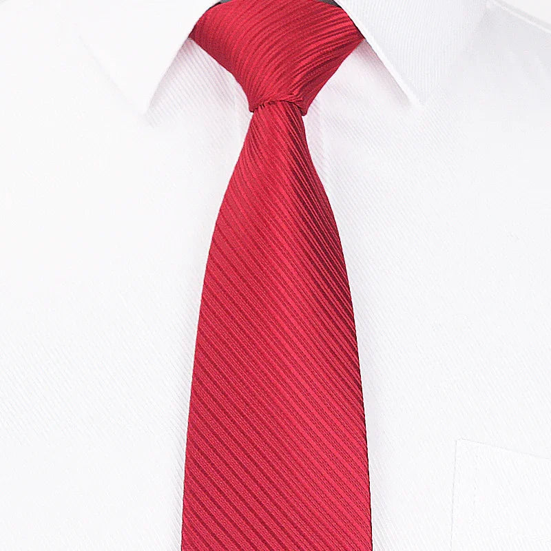 Close-up of a red striped necktie on a white dress shirt with a pocket