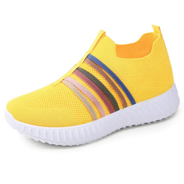 Yellow knit sneaker with white sole and multicolor stripes for casual athletic wear