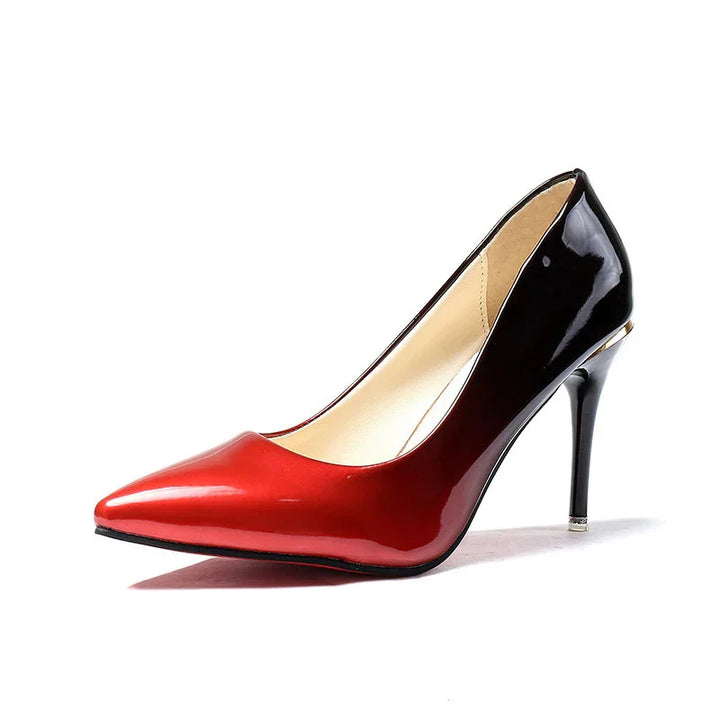 Women's pointed-toe high heel pump in red and black patent leather with stiletto heel