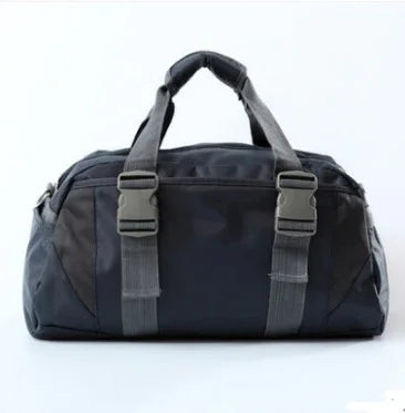 Black gym duffel bag with gray straps on a white background