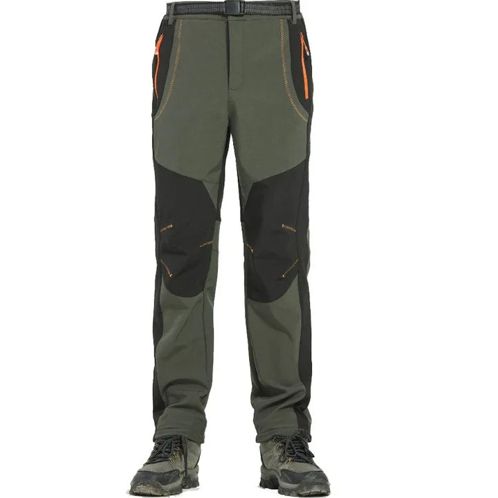 Men's outdoor hiking pants in green and black with orange zipper details and reinforced knees