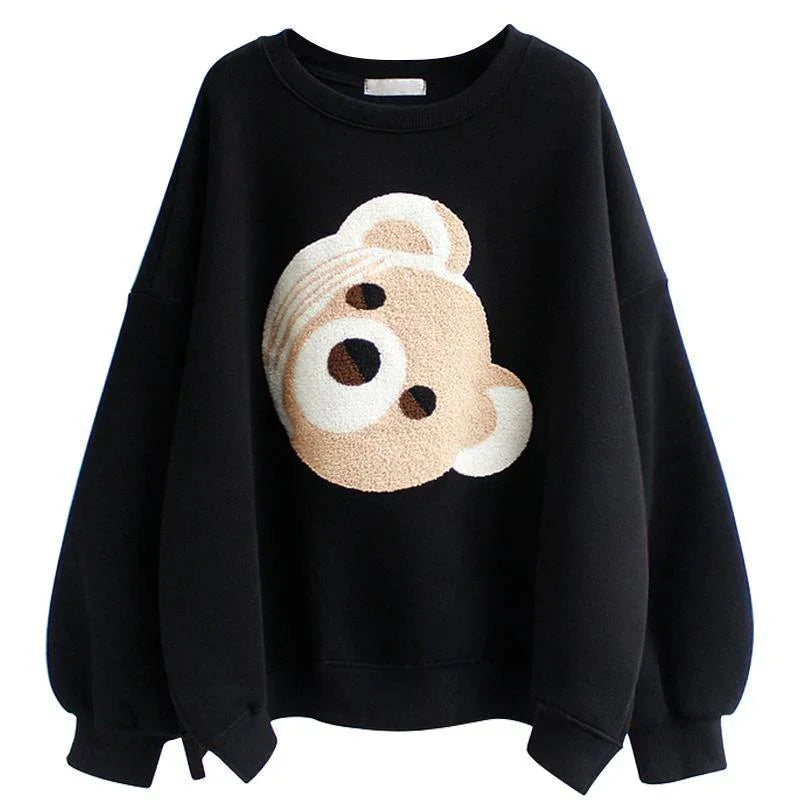 Black sweatshirt with oversized sleeves featuring a textured beige teddy bear face design
