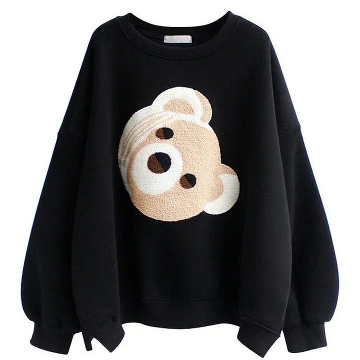 Black sweatshirt with oversized sleeves featuring a textured beige teddy bear face design