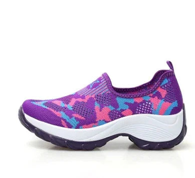 Purple slip-on athletic shoe with pink and blue camouflage pattern and white sole