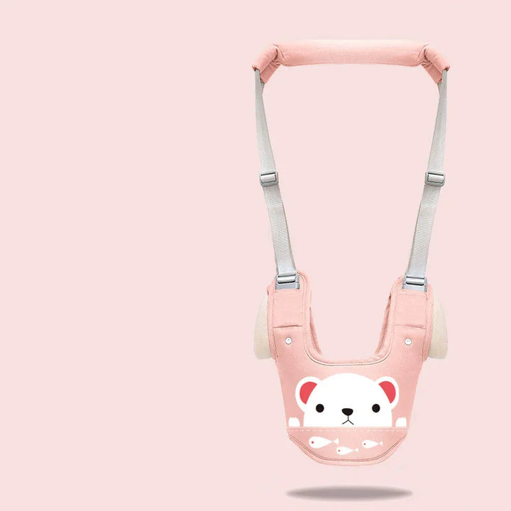 Pink baby safety harness with white bear face and fish design on pastel pink background