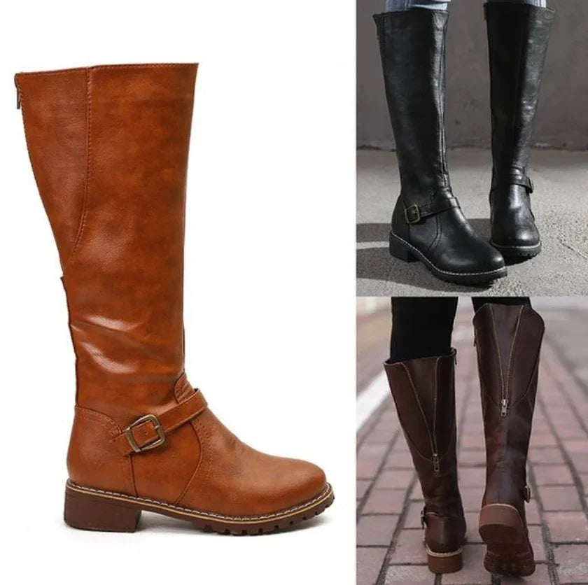 Brown and black knee-high leather boots with buckle and zipper details, shown on white background and worn outdoors.