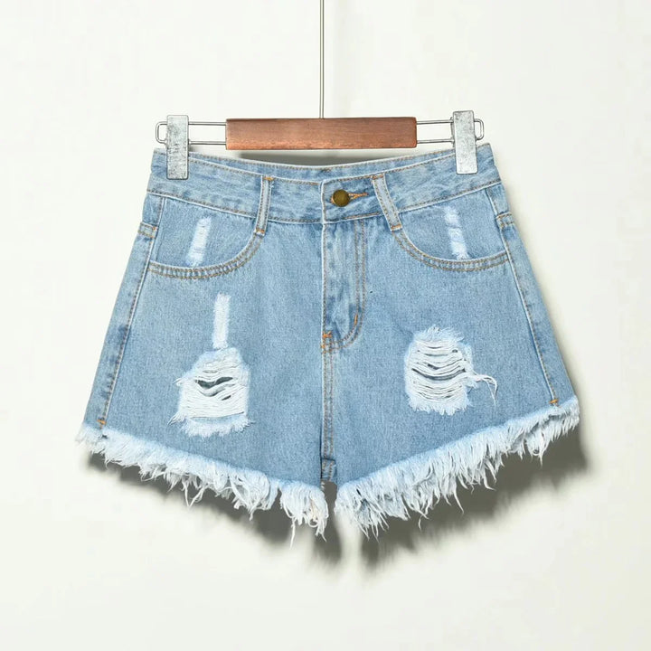 Light blue distressed denim shorts with frayed hem on wooden hanger