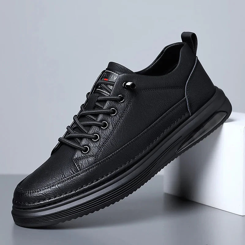 Black leather casual sneaker with thick sole and lace-up design displayed on gray background