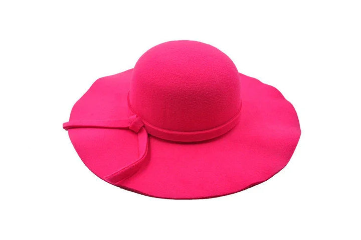 Bright pink wide-brimmed women's felt hat with bow detail on white background