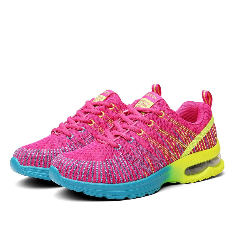 Bright pink and yellow athletic sneakers with blue soles and breathable mesh design