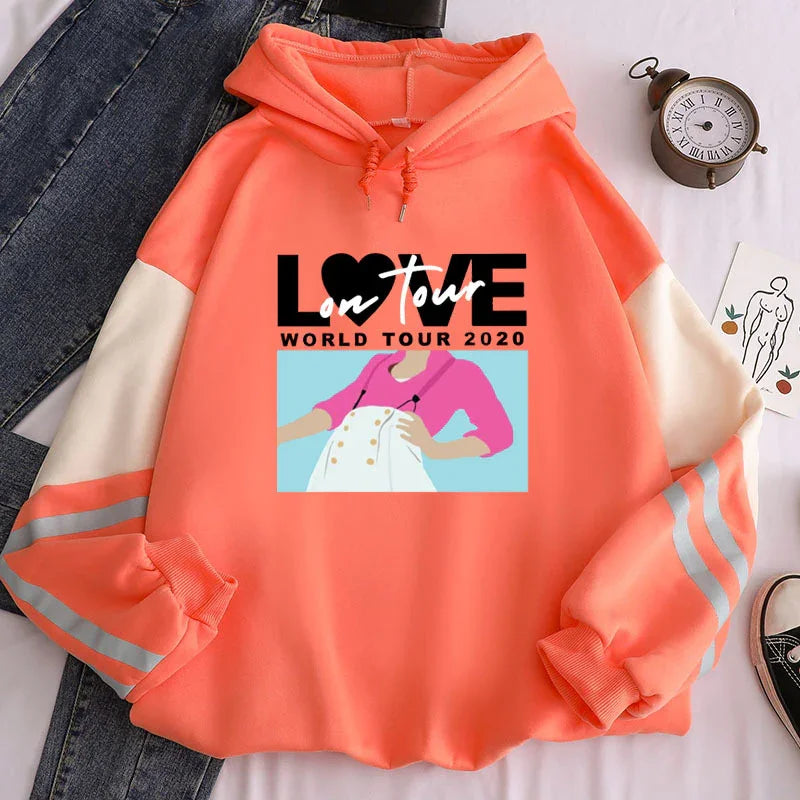 Coral orange hoodie with white sleeves and reflective stripes, featuring LOVE on tour world tour 2020 graphic