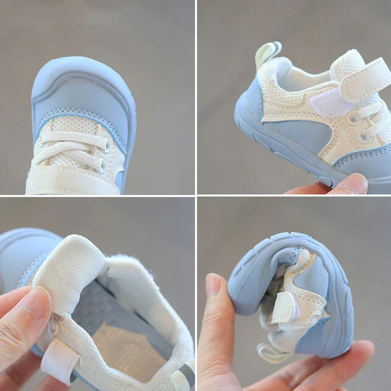 Light blue and white soft infant toddler sneakers showing flexible sole and breathable mesh