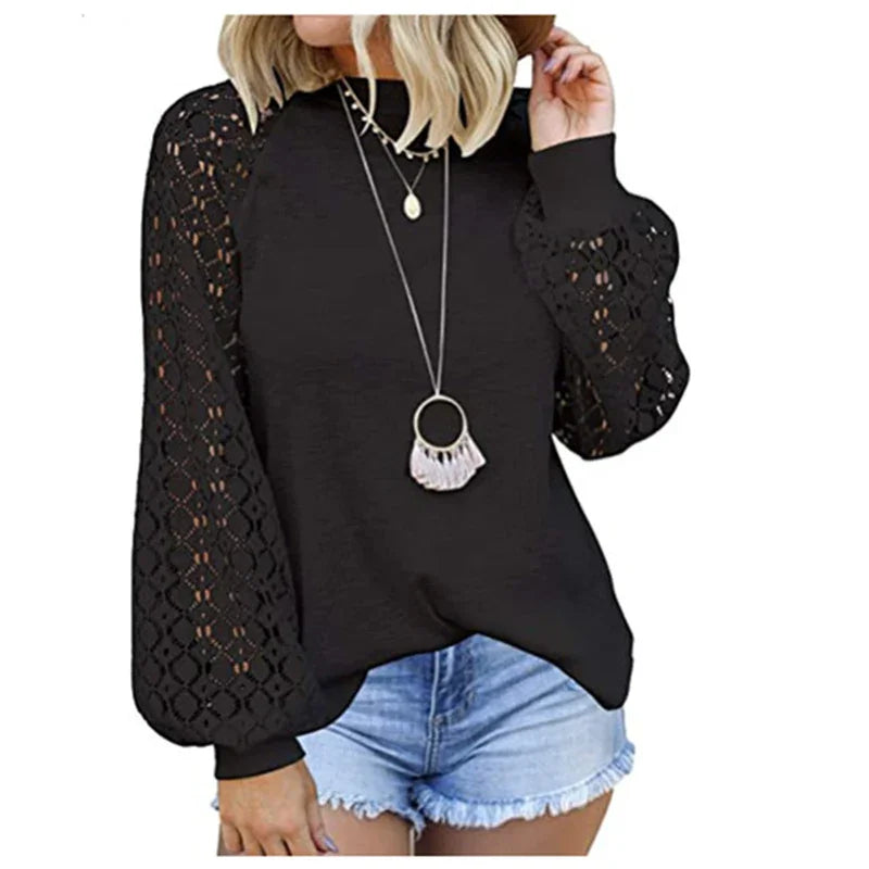 Woman wearing black blouse with lace balloon sleeves and denim shorts with layered necklaces