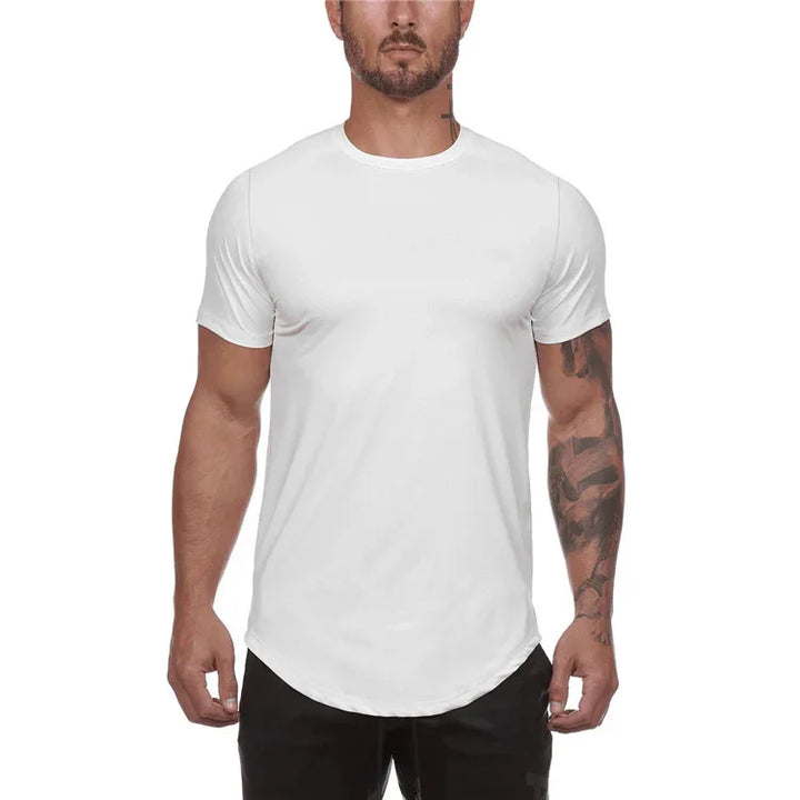 Man wearing fitted white short sleeve crew neck t-shirt with rounded hem and black pants