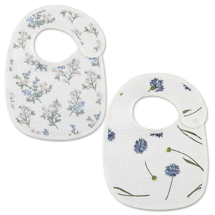 Two white baby bibs with floral prints, one with red and blue flowers, the other with blue flowers and green stems