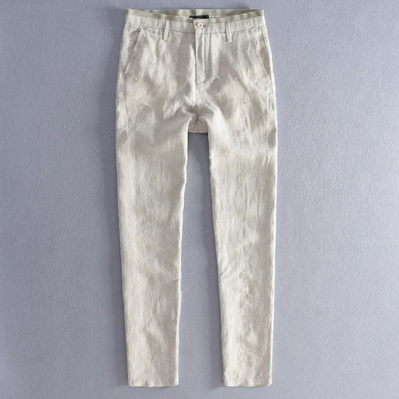 Light beige slim-fit casual pants with button closure on gray background