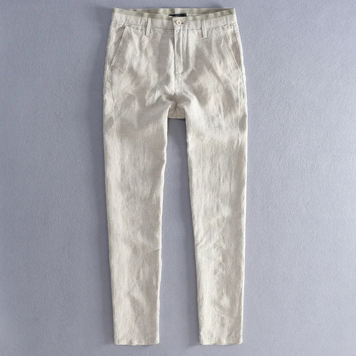 Light beige slim-fit casual pants with button closure on gray background