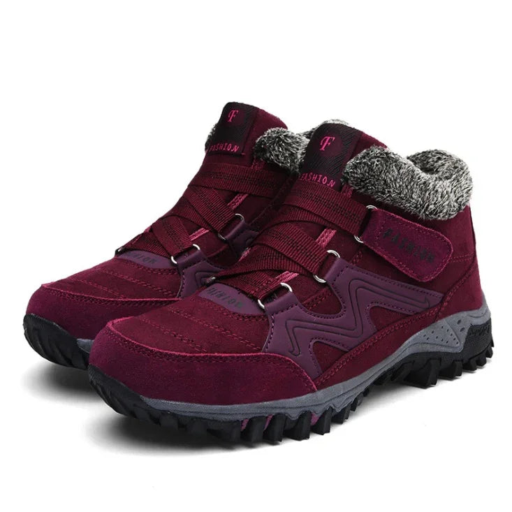 Burgundy winter hiking boots with faux fur lining and rugged black soles on white background
