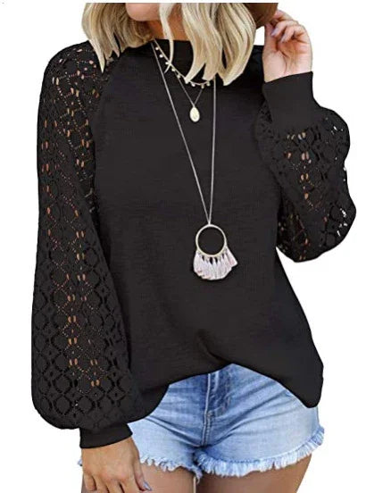 Woman wearing black lace balloon sleeve top and denim shorts with layered necklaces