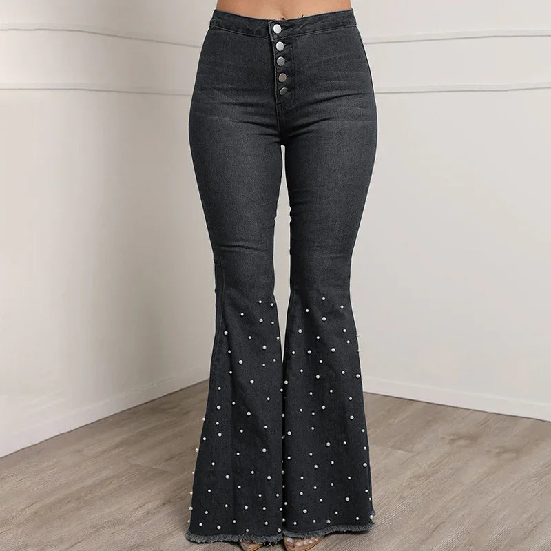 Black high-waisted flare jeans with silver buttons and pearl embellishments on legs