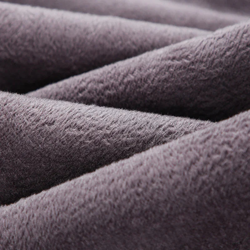 Close-up of soft, textured gray fleece fabric folds for warm clothing and blankets