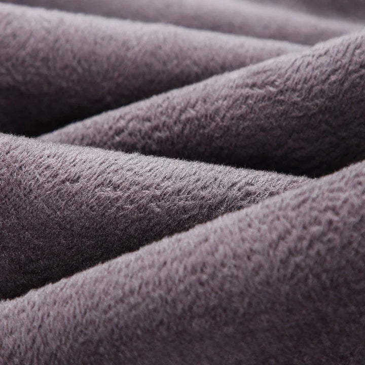 Close-up of soft, textured gray fleece fabric folds for warm clothing and blankets