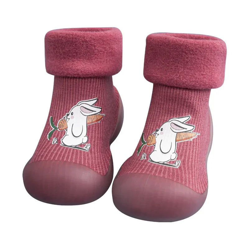 Pink toddler shoes with soft cuffs and cartoon bunny holding carrot design on top
