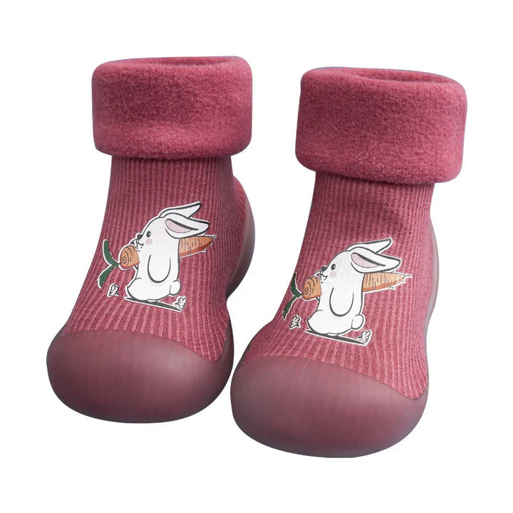 Pink toddler shoes with soft cuffs and cartoon bunny holding carrot design on top