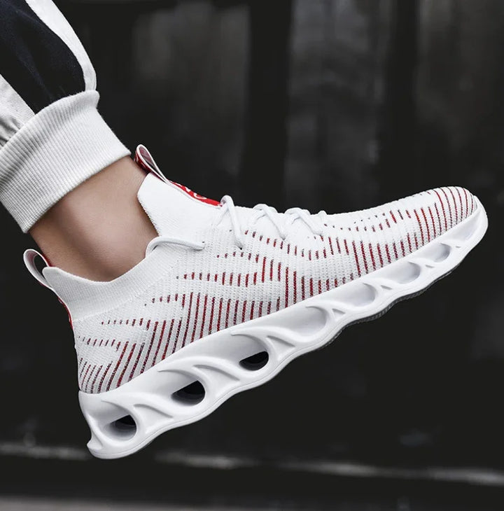 white breathable knit athletic sneaker with red stripes and cushioned sole on foot