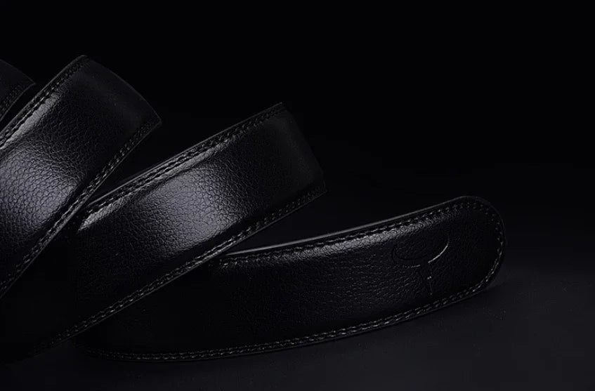 Close-up of a black leather guitar strap with embossed logo on dark background