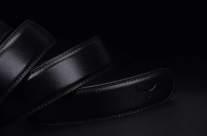 Close-up of a black leather guitar strap with embossed logo on dark background